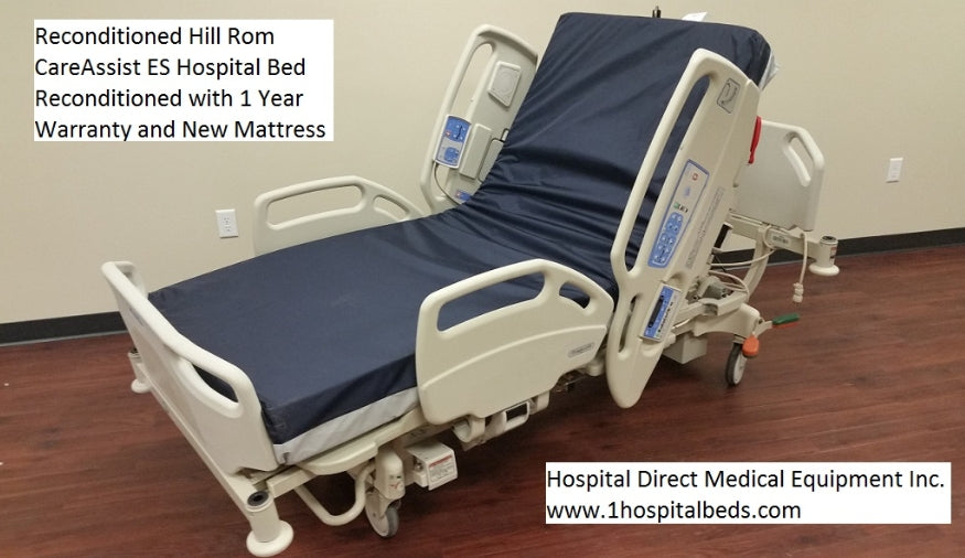 Hospital bed with foam mattress, Hill Rom 11170 Care Assist model, featuring adjustable side rails and control panel.
