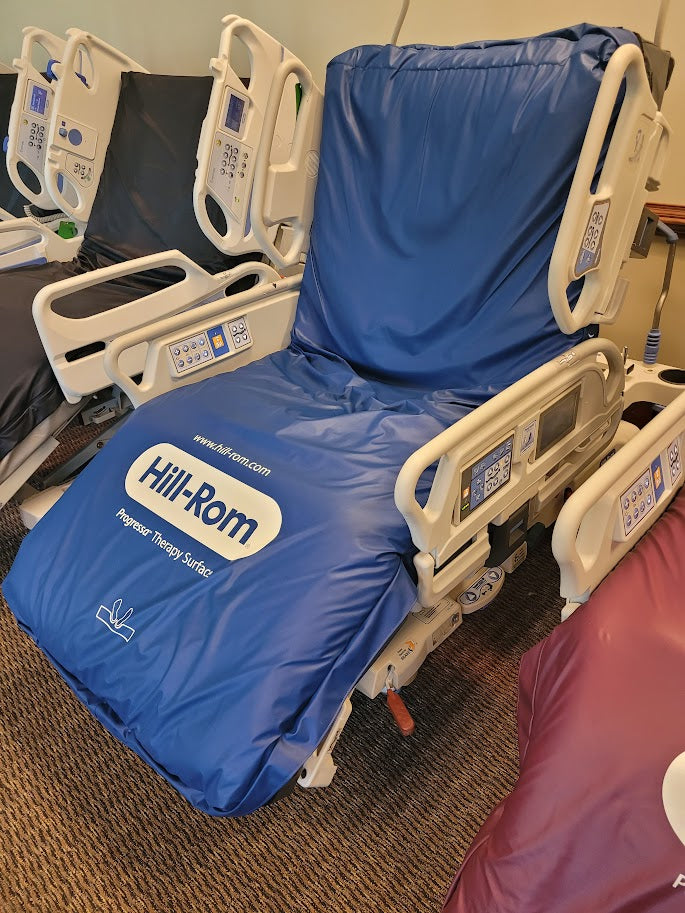 Hill Rom P7500 Progressa hospital bed with low air loss therapy mattress for patient comfort and pressure relief.
