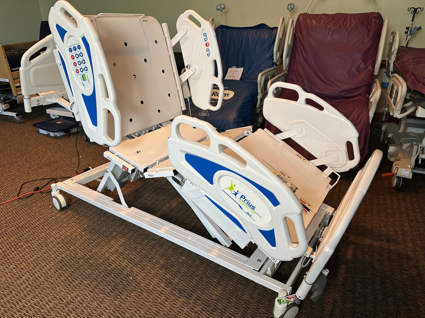 Prius Ai1 bariatric hospital bed with extra-wide high low adjustable frame and side rails for patient comfort and safety.