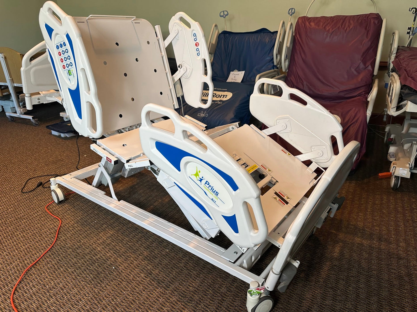 Prius Ai1 bariatric hospital bed with extra-wide, high-low adjustable features, designed for patient comfort and medical care.