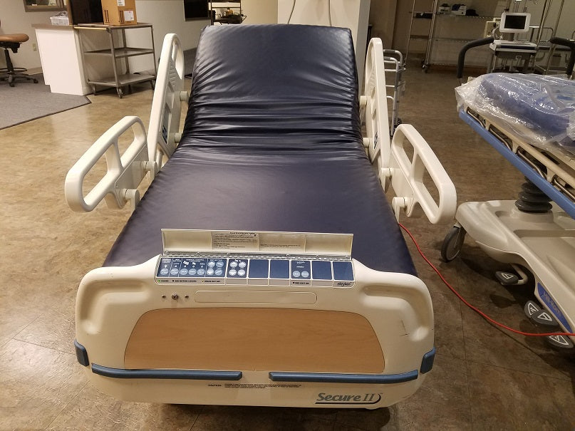 StrykerSecure2HospitalBedHospital bed with control panel in a room setting