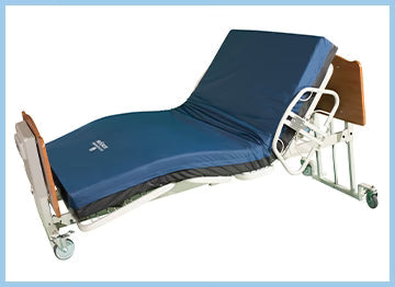 comfort-wide-bariatric-low-bed Hospital bed with blue mattress on a white background