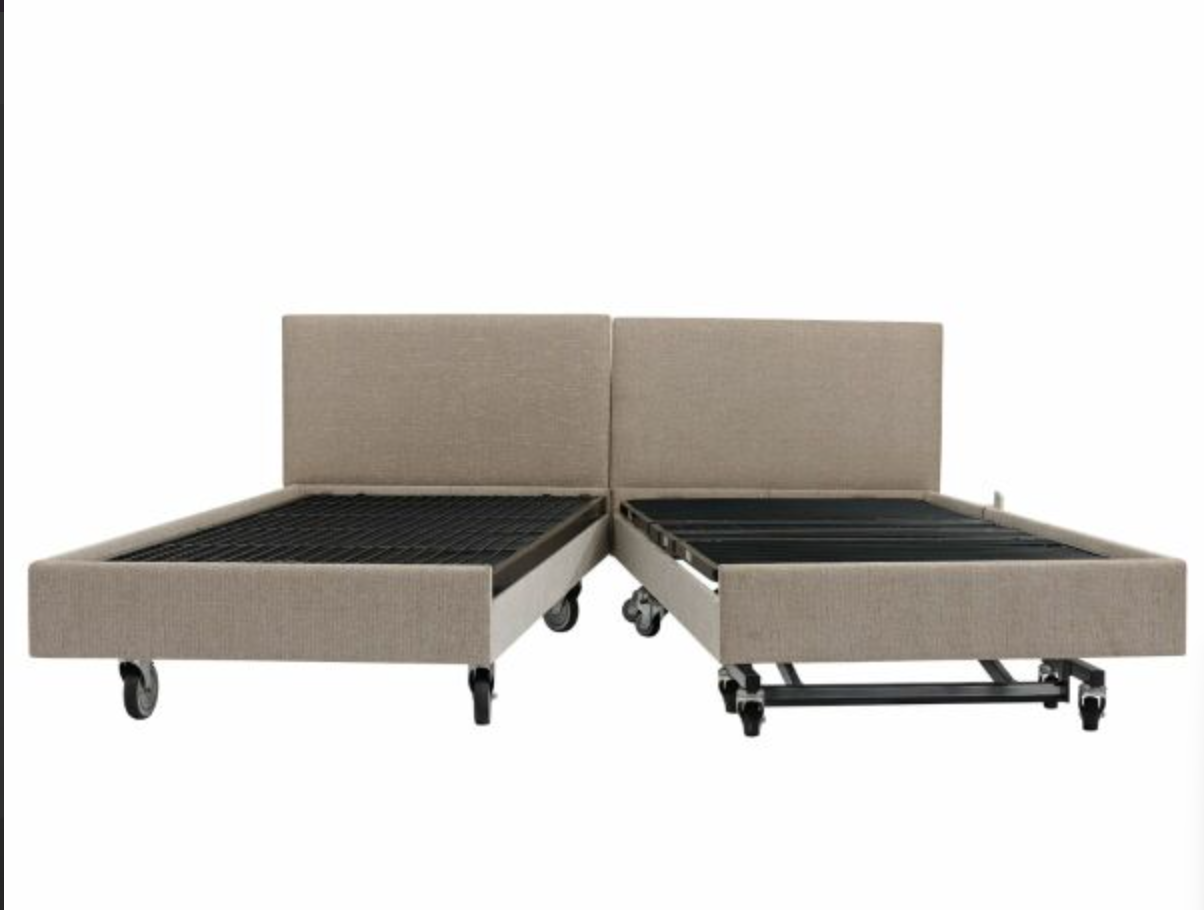An electric motorized convertible bed frame shown in its unfolded position, featuring beige upholstered side rails and headboard with black slatted metal bedsides and wheels on a white background.